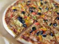 Pyszna pizza z oliwkami, papryką i serem. To jest właśnie to, co to jest pizza – idealna na każdą okazję!