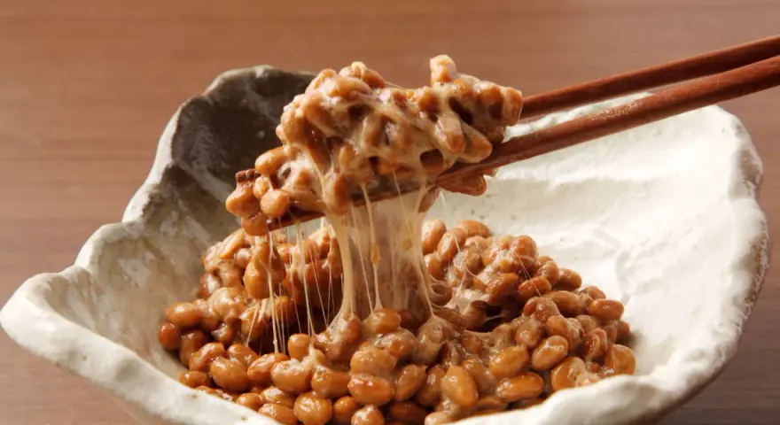 Natto co to? Sfermentowana soja z charakterystyczną, ciągnącą się konsystencją, podana w miseczce, nabierana pałeczkami.